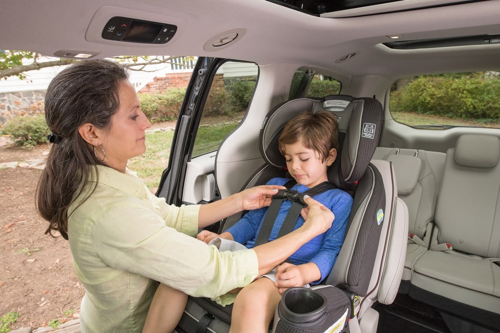 mom with child in a car seat NHTSA