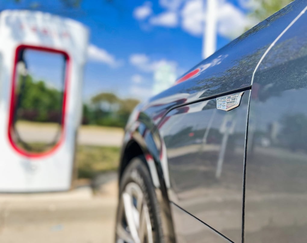  Cadillac LYRIQ EV parked at a Tesla Supercharger station. Photo Credit: General Motors.