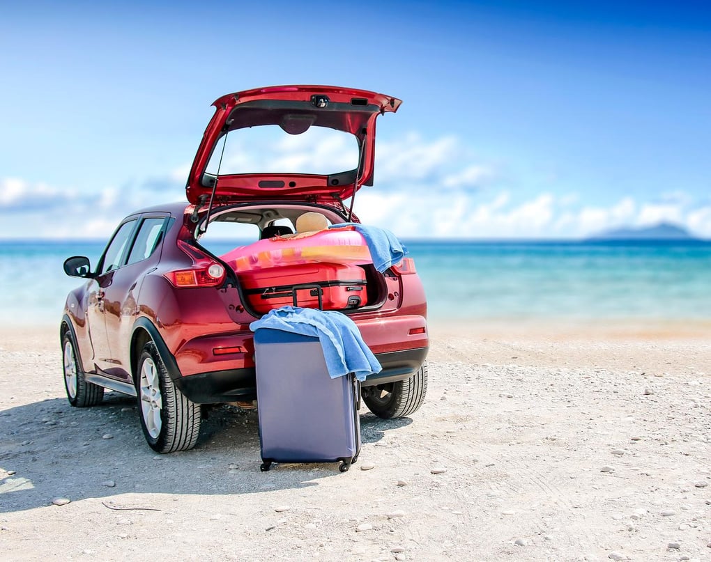 Beach with SUV and luggage