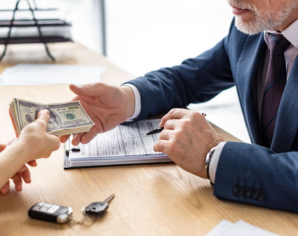 Paying cash for cars at the dealership