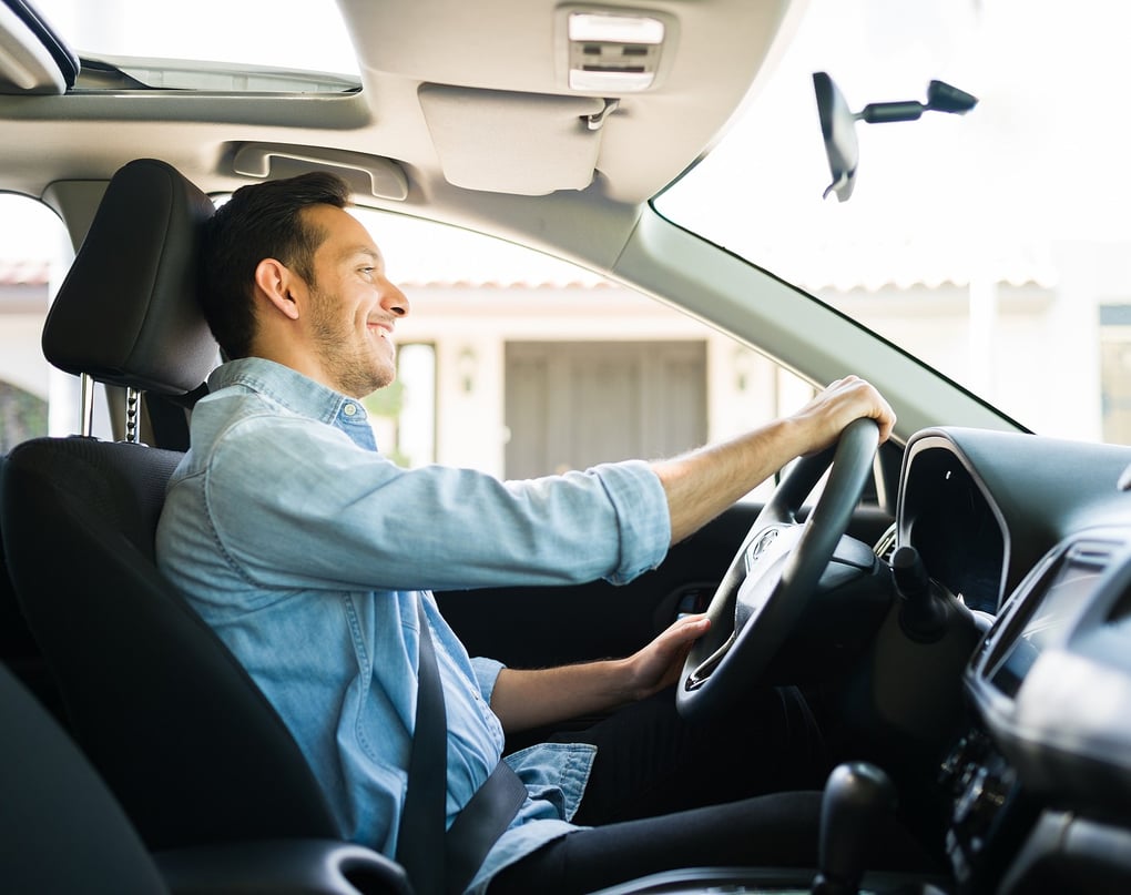 Man smiling in the car happy with his vehicle